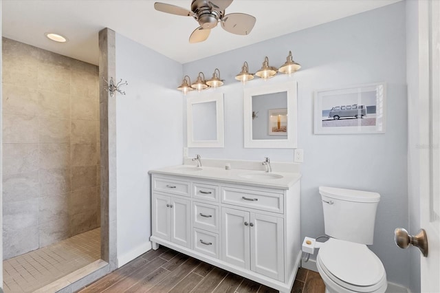 bathroom featuring a walk in shower, a sink, toilet, and wood tiled floor