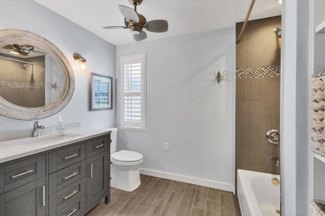 full bathroom featuring shower / bathing tub combination, toilet, wood tiled floor, vanity, and baseboards