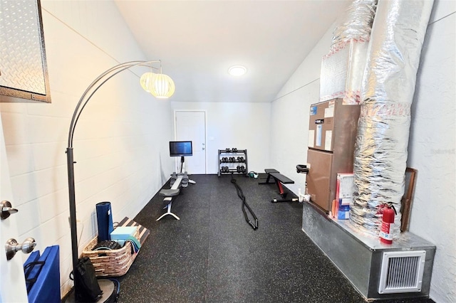 workout room with lofted ceiling