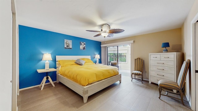 bedroom featuring a ceiling fan and baseboards