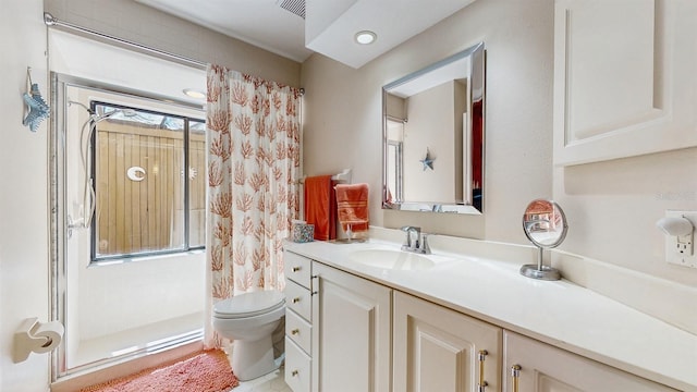 bathroom with curtained shower, toilet, vanity, and visible vents