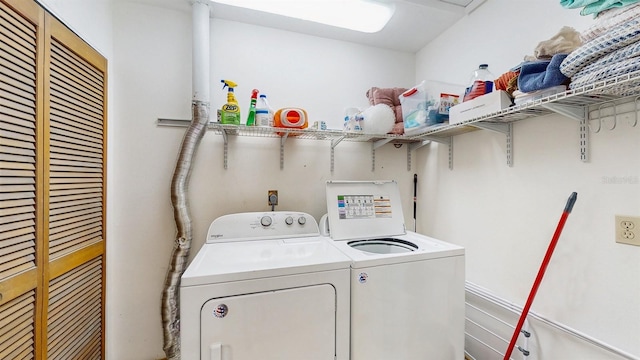 clothes washing area featuring washer and dryer and laundry area