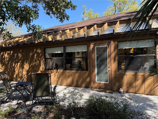 exterior space featuring a shingled roof