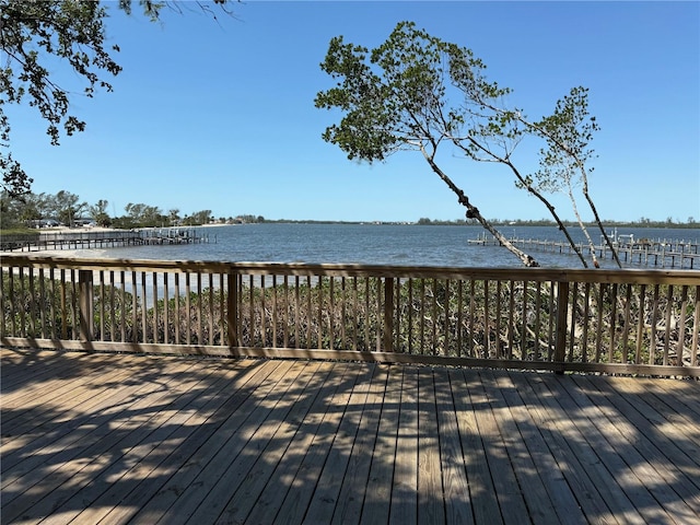 wooden terrace featuring a water view