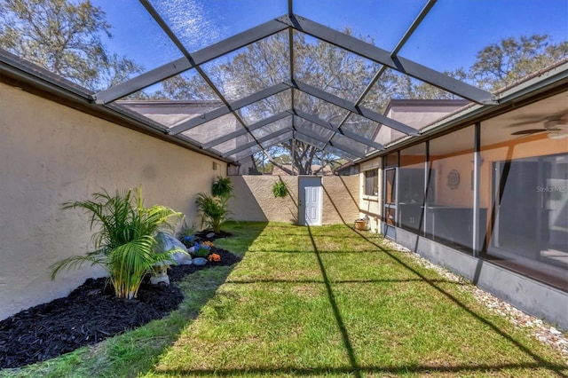 view of yard with glass enclosure