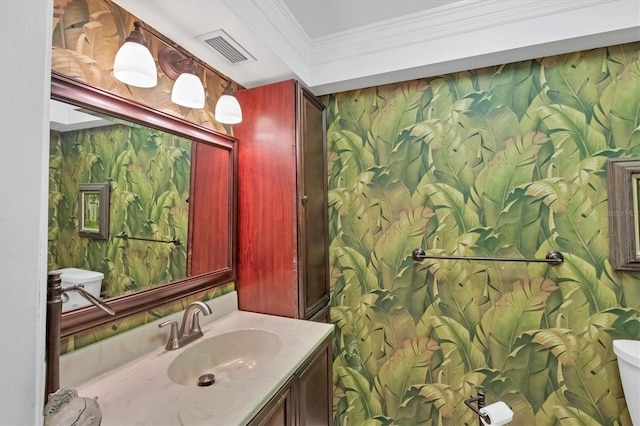 half bath featuring visible vents, wallpapered walls, crown molding, toilet, and vanity