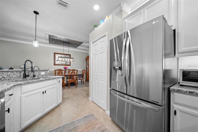 kitchen featuring ornamental molding, white cabinetry, a sink, and stainless steel refrigerator with ice dispenser