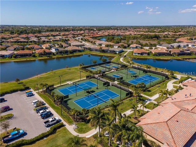 drone / aerial view featuring a water view and a residential view