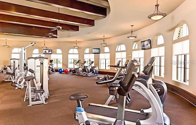 gym with a ceiling fan and baseboards