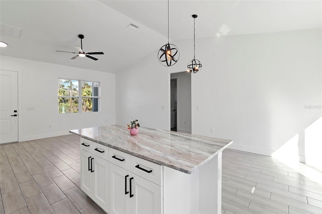 kitchen with a center island, visible vents, open floor plan, and wood finish floors