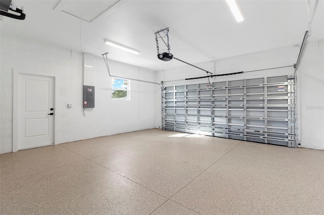 garage featuring a garage door opener and electric panel