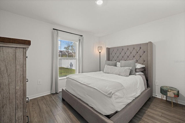 bedroom with baseboards and wood finished floors