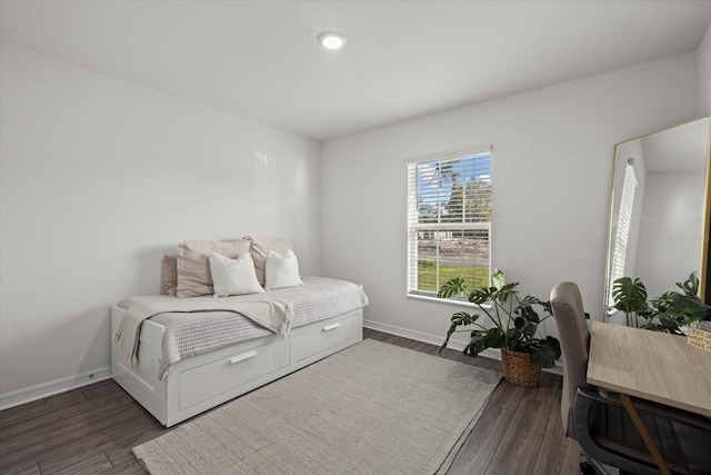 bedroom featuring dark wood-style floors and baseboards