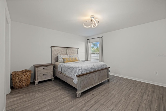 bedroom featuring wood finished floors and baseboards