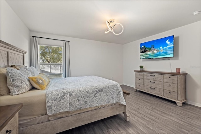 bedroom featuring baseboards and wood finished floors