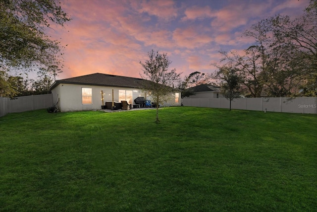 view of yard with a patio area and a fenced backyard