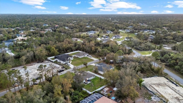 birds eye view of property with a residential view and a view of trees