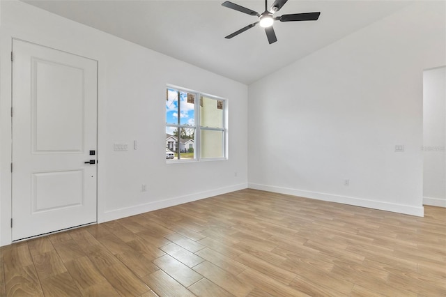 unfurnished room featuring lofted ceiling, light wood finished floors, ceiling fan, and baseboards