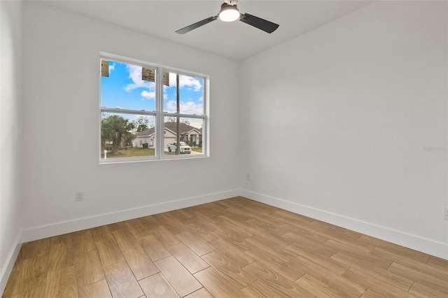 empty room with light wood-type flooring, ceiling fan, and baseboards