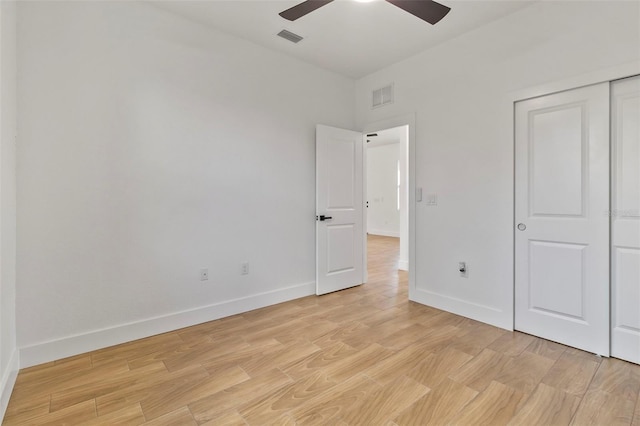 unfurnished bedroom featuring light wood-type flooring, baseboards, and visible vents