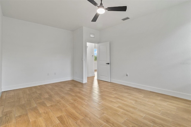 empty room with light wood finished floors, visible vents, baseboards, and a ceiling fan