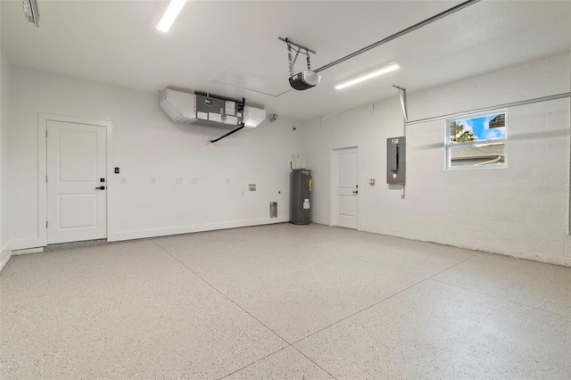 garage with a garage door opener, concrete block wall, electric panel, and electric water heater