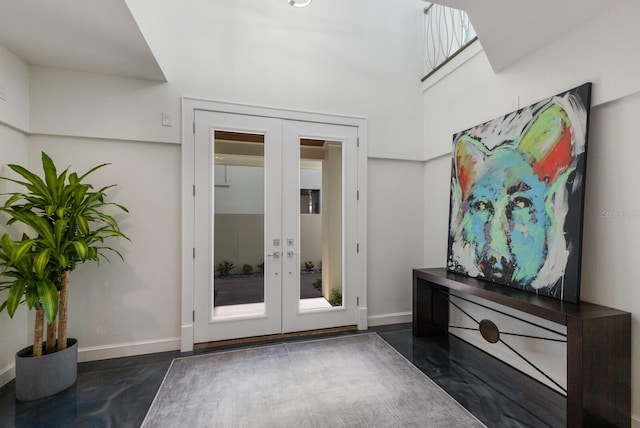 doorway to outside featuring french doors and baseboards