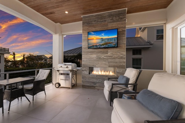 view of patio featuring an outdoor living space with a fireplace and a grill