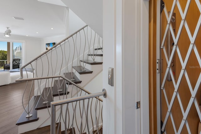 stairs featuring crown molding, recessed lighting, and wood finished floors