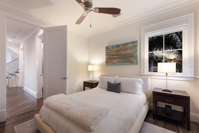 bedroom featuring ceiling fan, crown molding, baseboards, and wood finished floors