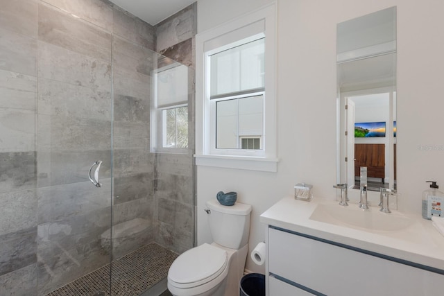 bathroom with vanity, toilet, and a stall shower