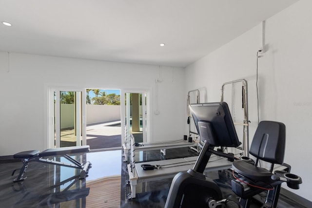 exercise room with recessed lighting and wood finished floors