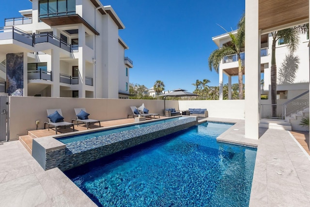 view of pool with a patio area, a fenced in pool, and fence