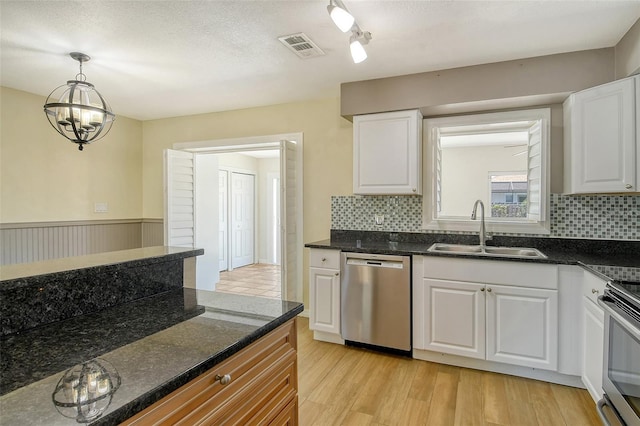 kitchen featuring white cabinets, light wood-style flooring, stainless steel appliances, and a sink