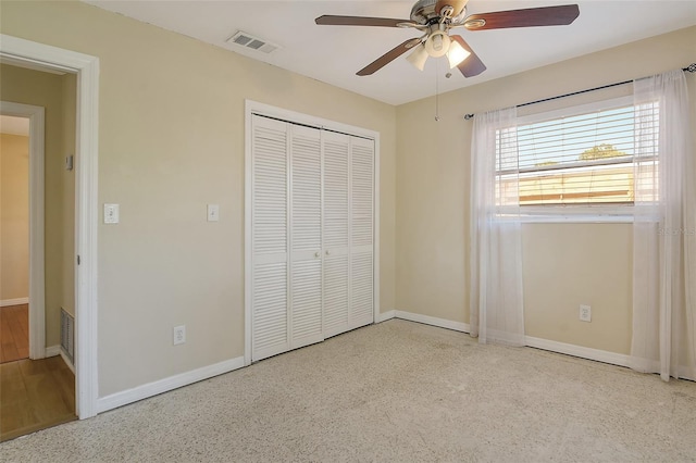 unfurnished bedroom featuring a ceiling fan, baseboards, visible vents, and a closet