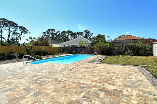 view of pool with a patio, a yard, a fenced backyard, and a fenced in pool