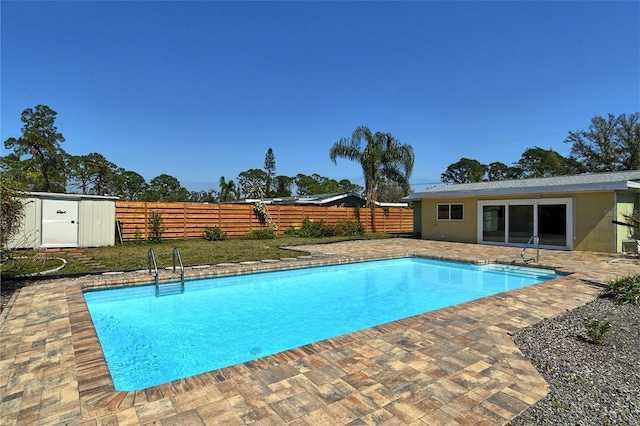 view of pool featuring a fenced backyard, a fenced in pool, a patio, and an outdoor structure