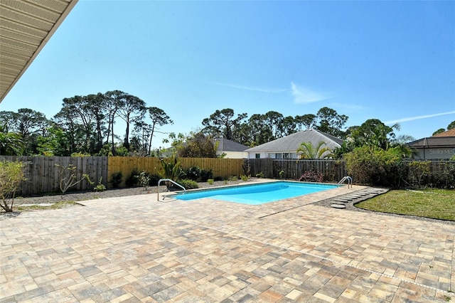 view of pool featuring a fenced in pool, a fenced backyard, and a patio