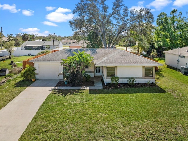 ranch-style house with fence, a front yard, stucco siding, a garage, and driveway