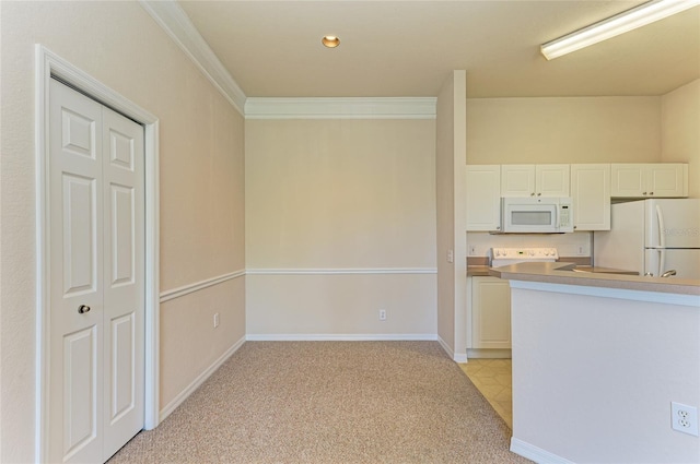 kitchen featuring light colored carpet, ornamental molding, white cabinets, white appliances, and baseboards