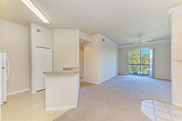 interior space with ceiling fan, light carpet, a peninsula, visible vents, and freestanding refrigerator