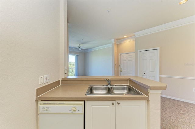 kitchen with white cabinets, ornamental molding, white dishwasher, carpet flooring, and a sink