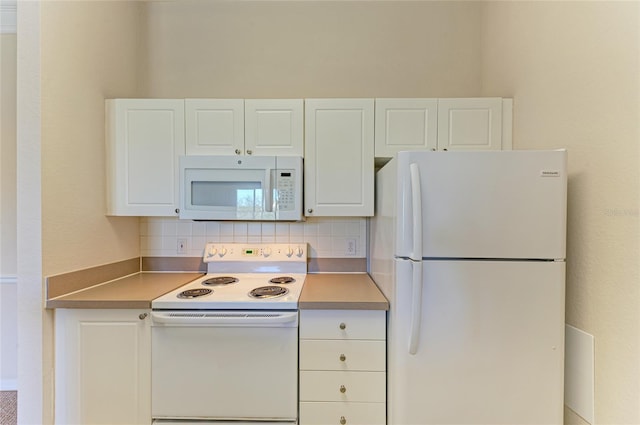 kitchen featuring white appliances, backsplash, and white cabinets