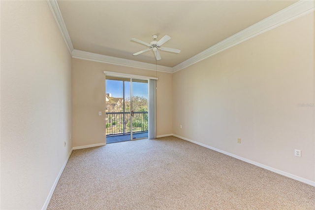 empty room with carpet floors, ceiling fan, baseboards, and crown molding