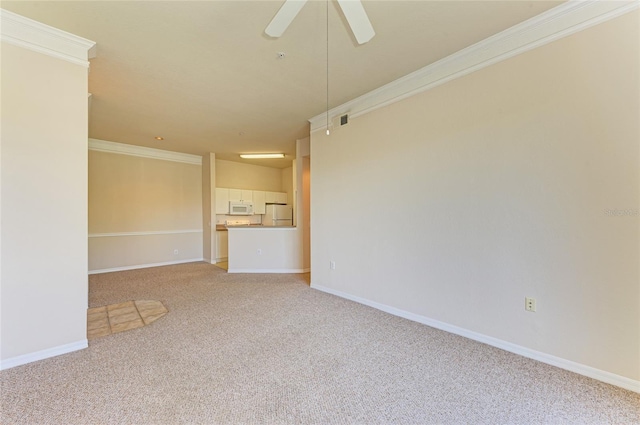 empty room with light carpet, crown molding, visible vents, and baseboards