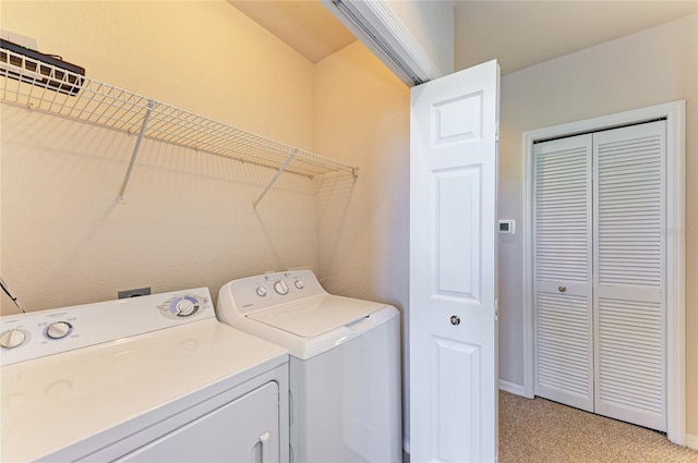 washroom featuring laundry area, baseboards, separate washer and dryer, and light colored carpet