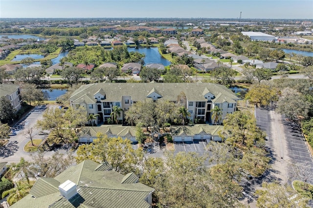 birds eye view of property with a water view and a residential view