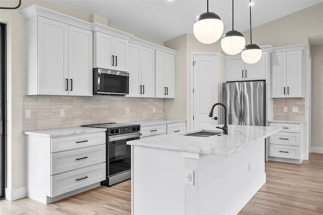 kitchen with light wood-style flooring, freestanding refrigerator, electric range oven, and a sink