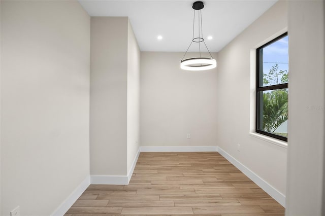 spare room with recessed lighting, light wood-style flooring, and baseboards