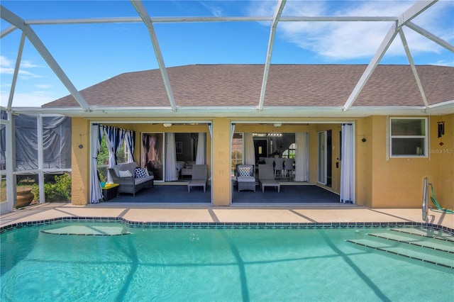 rear view of house with a patio area, roof with shingles, an outdoor pool, and an outdoor hangout area